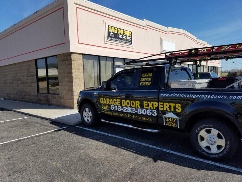 Garage Door Experts service truck parked outside a commercial building