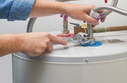 A professional repairing water heater.