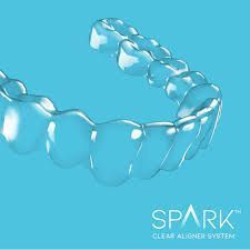 Spark clear aligner system on a blue background.