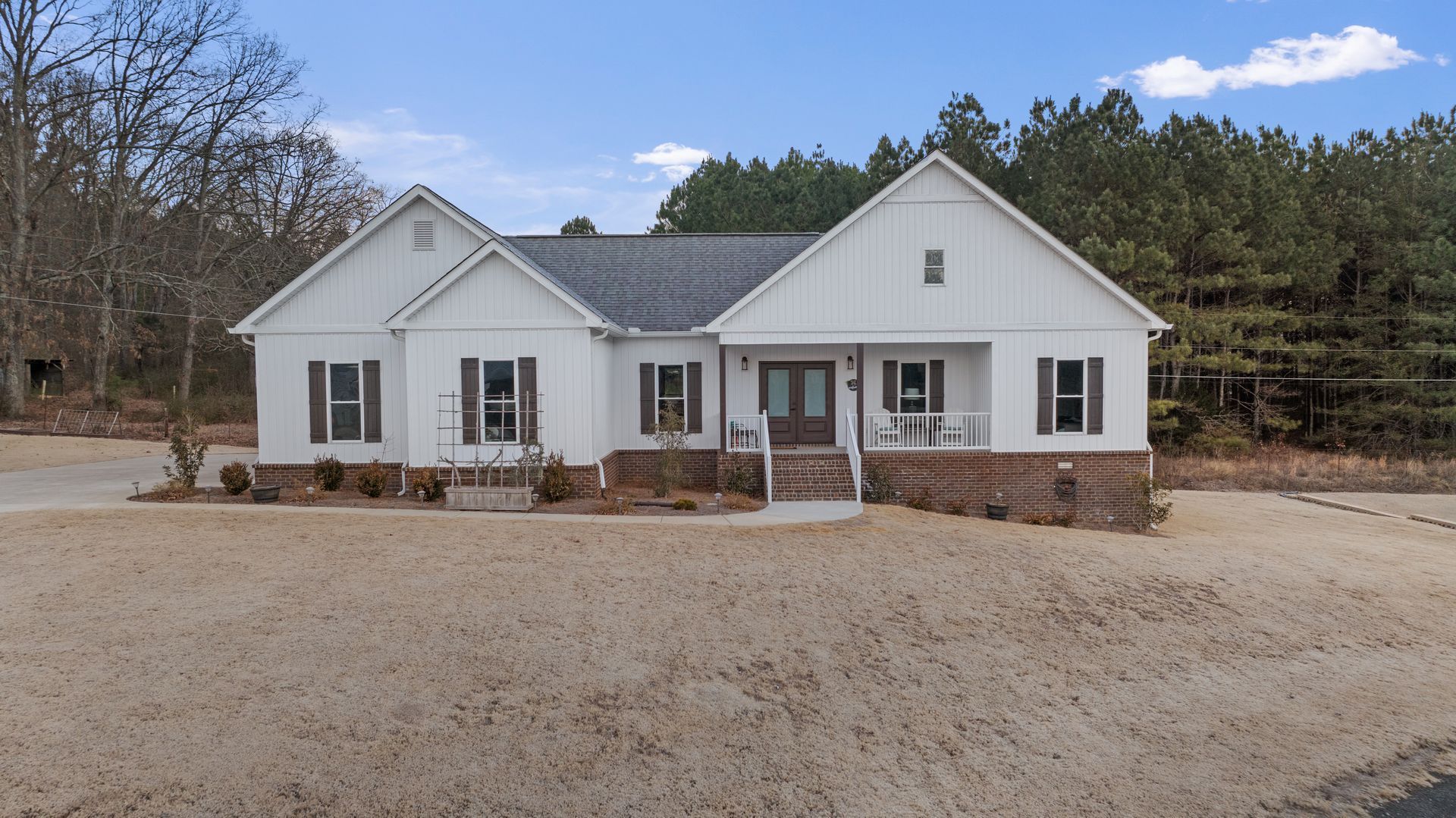 A large white house with a lot of windows and shutters