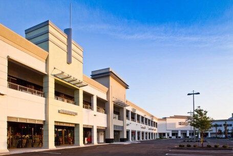 A large building with a lot of windows and a cross on top of it
