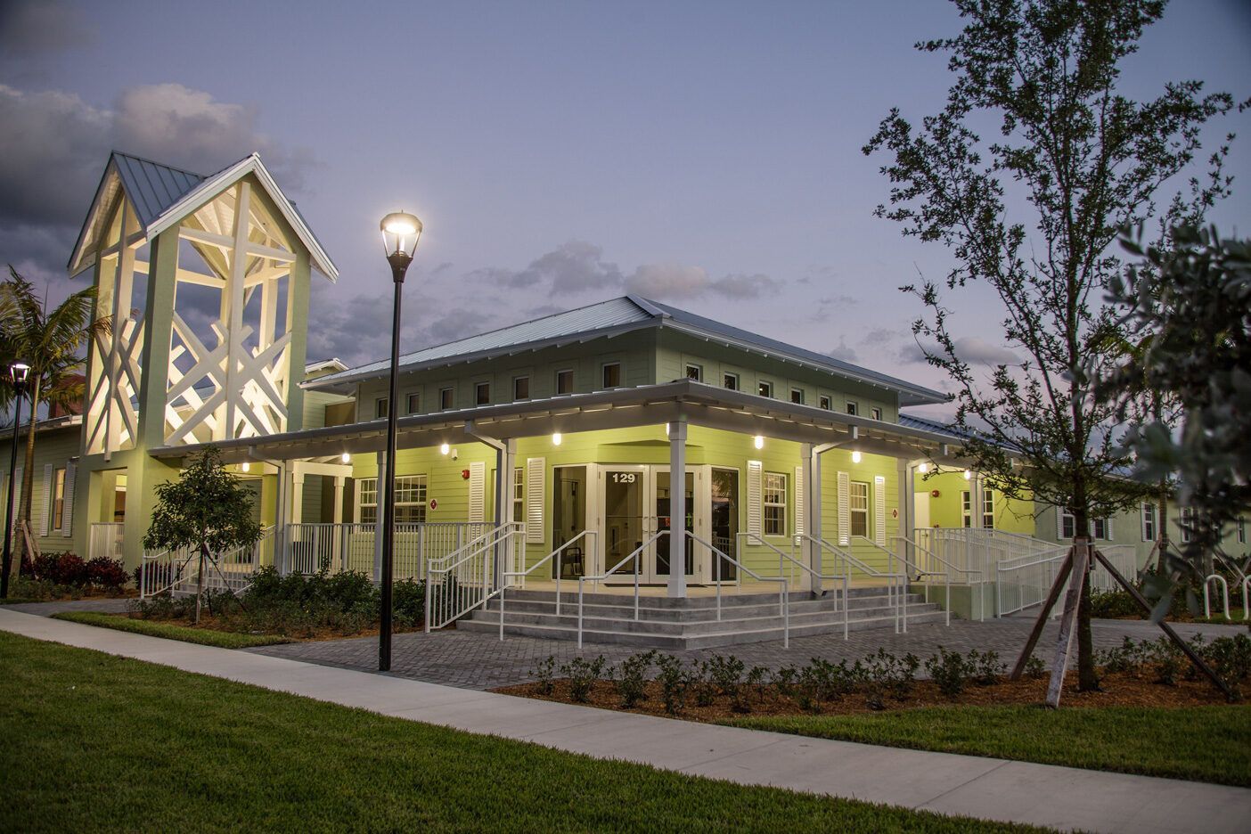 A large building with a porch and a street light in front of it