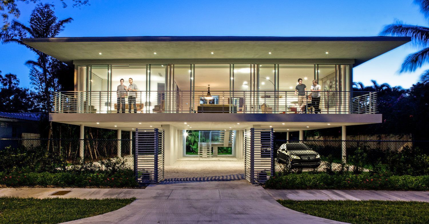 A modern house with a car parked in front of it