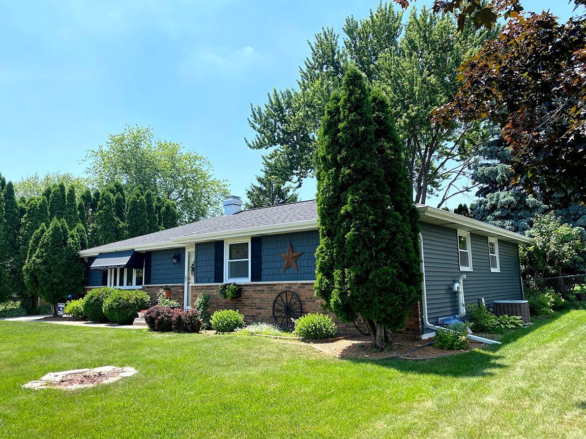 A house with a large lawn in front of it.