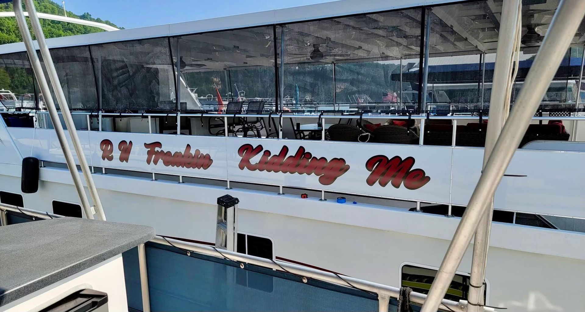 A white boat with red writing on the side of it
