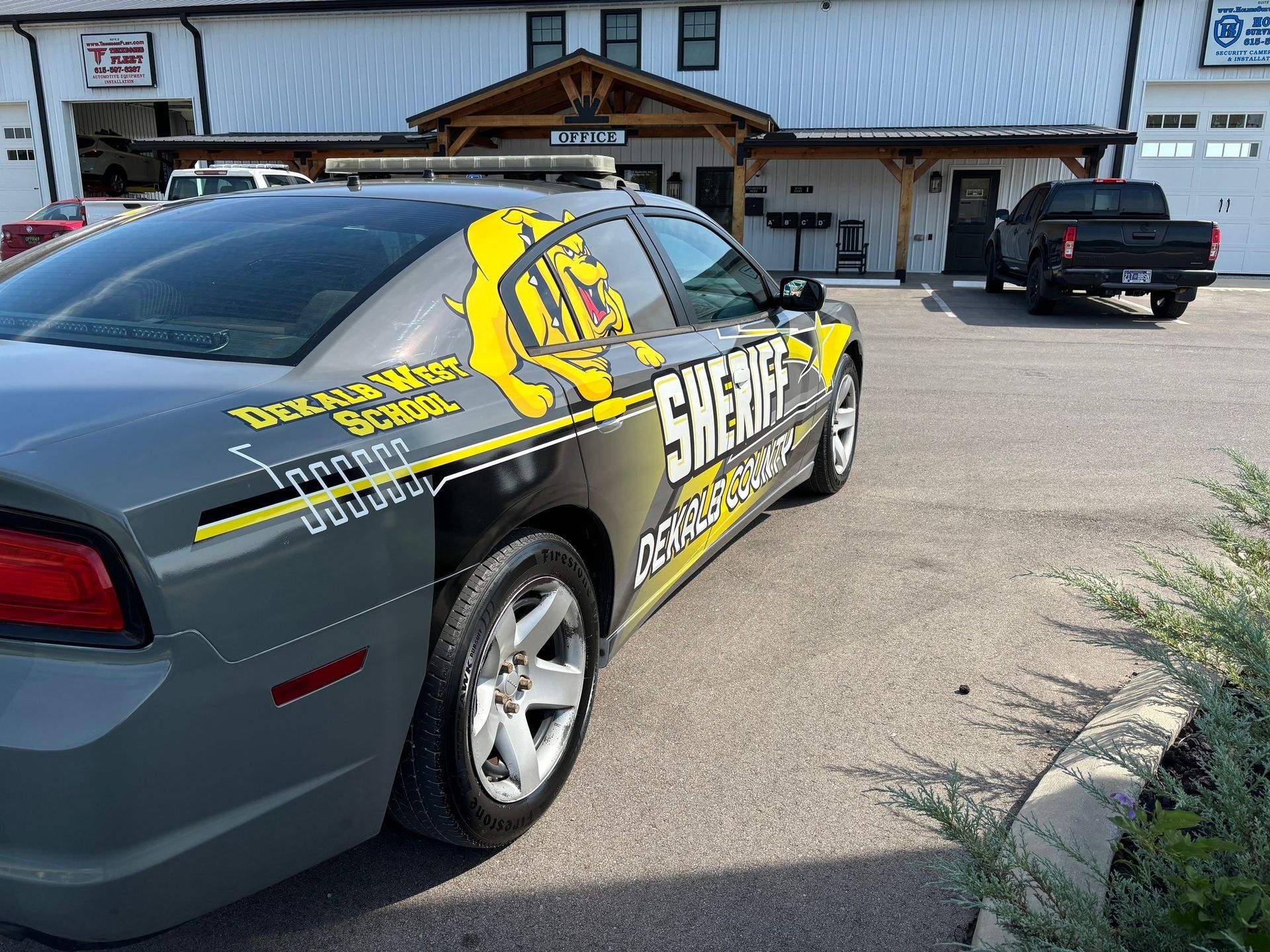 A sheriff 's car is parked in front of a building.