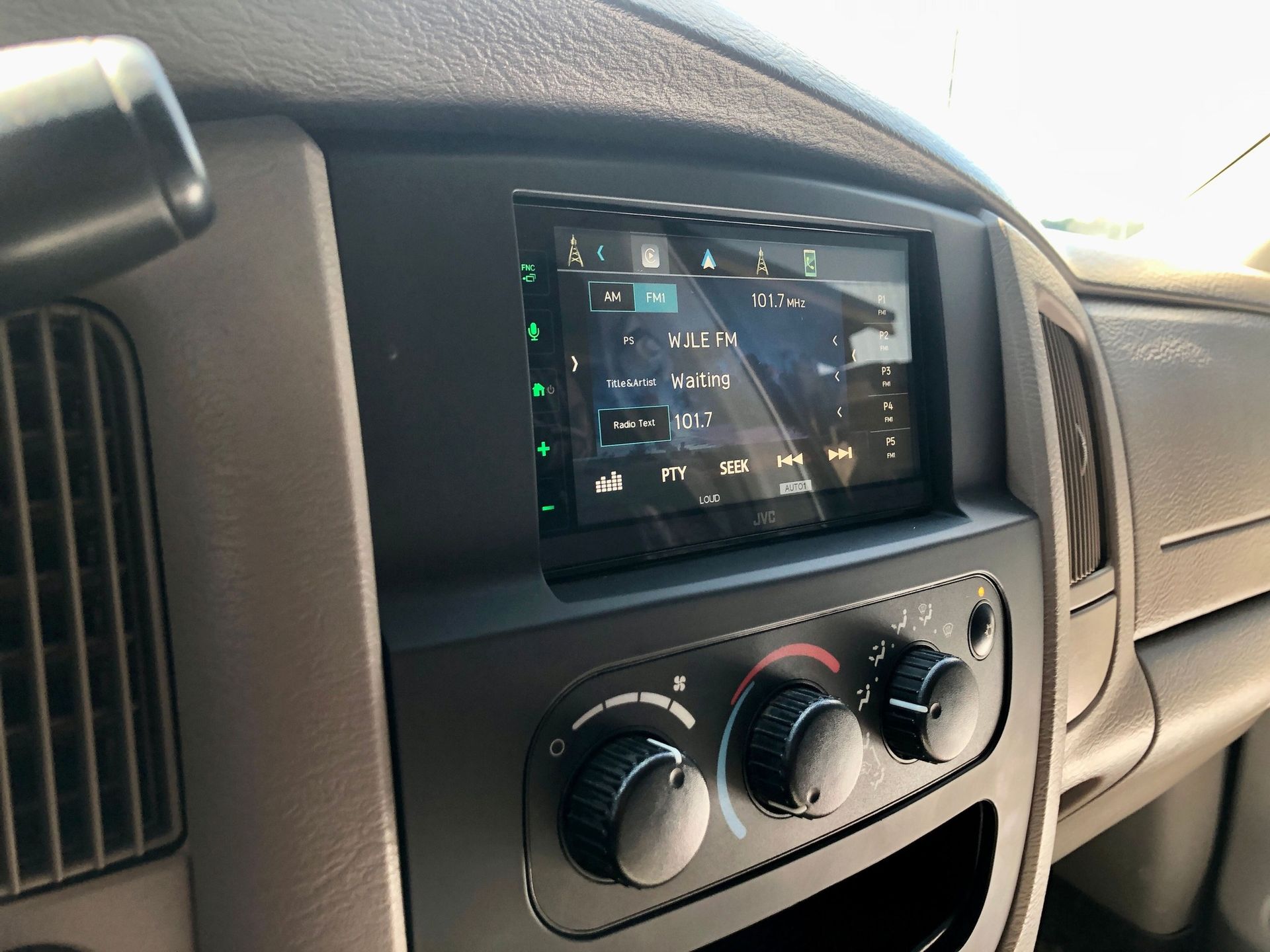 A close up of a car dashboard with a radio on it