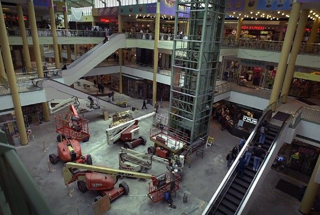 An aerial view of a shopping mall with a lot of machinery and escalators.