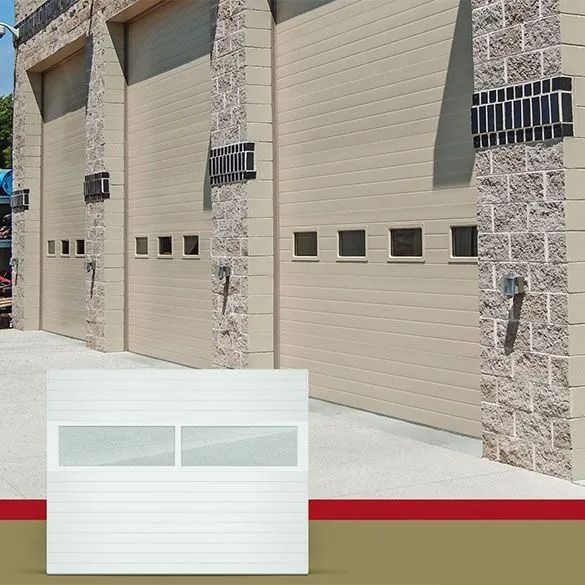 Row of tan garage doors on a stone building, with a small garage-door inset at the bottom left.