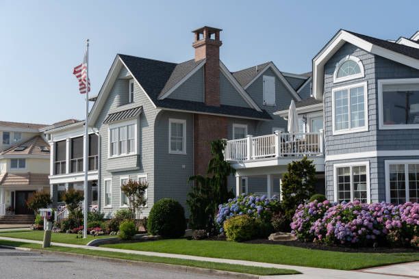 A row of houses on a sunny day with a flag in the foreground