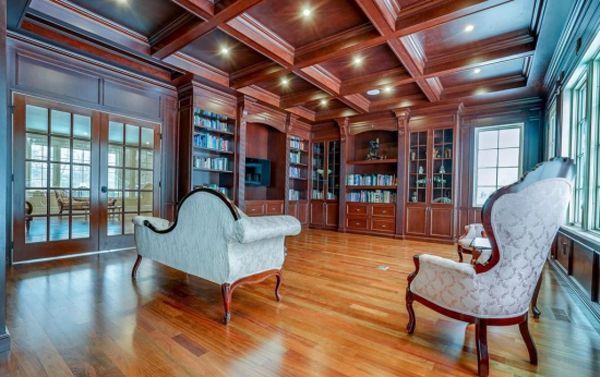 A living room with hardwood floors , a couch and chairs.