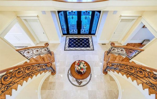 An aerial view of a staircase in a house with a table in the middle.