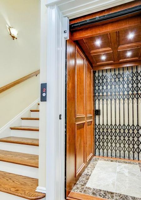 A wooden elevator with stairs leading up to it