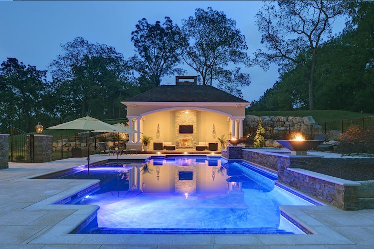 A large swimming pool with a gazebo in the background