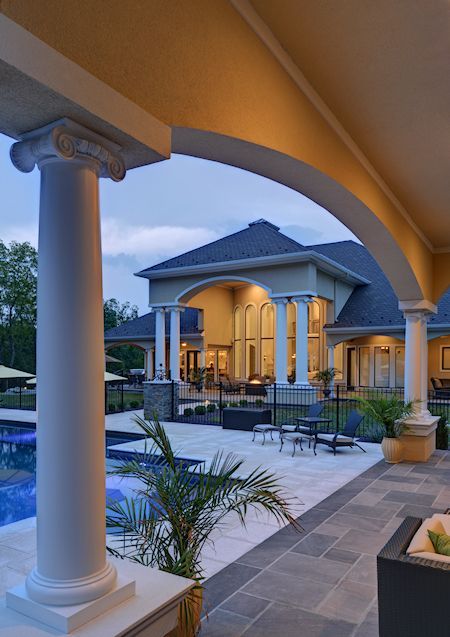 A large house with columns and a swimming pool