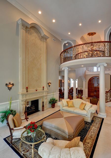 A living room with a fireplace and a balcony