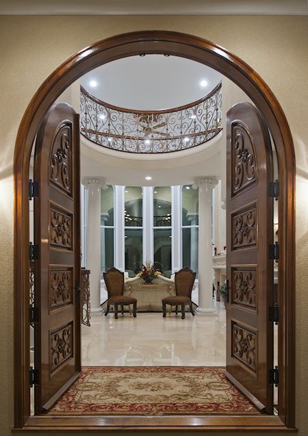 A view of a living room through an arched door