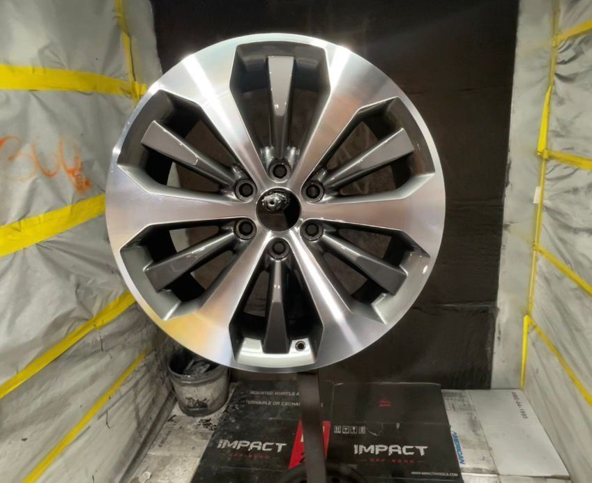 Silver and black alloy wheel with 10 spokes - after