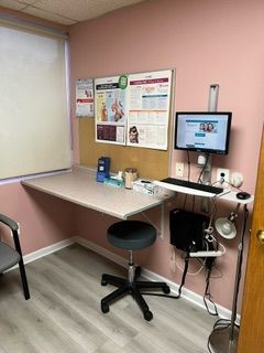 A room with a desk and a computer on it