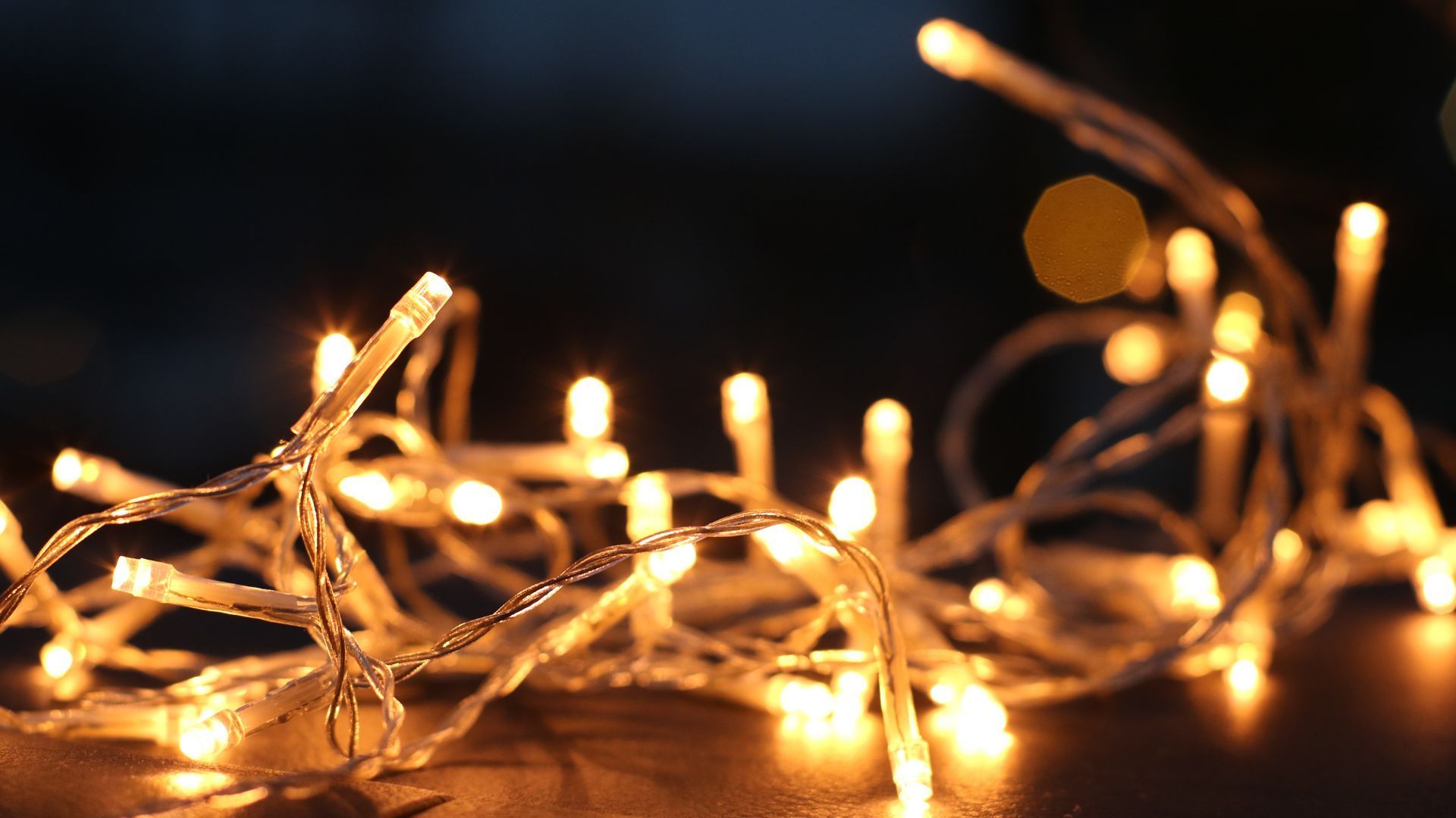 Twinkling warm white string lights against a dark background.