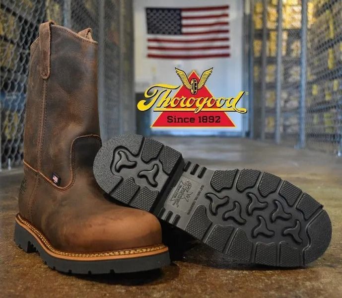 Brown work boots with thick black soles; Thorogood logo and American flag in the background.