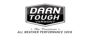 Logo of Darn Tough Vermont socks. A black and white hexagon badge with the brand name. The tagline reads, “All Weather Performance Sock”.