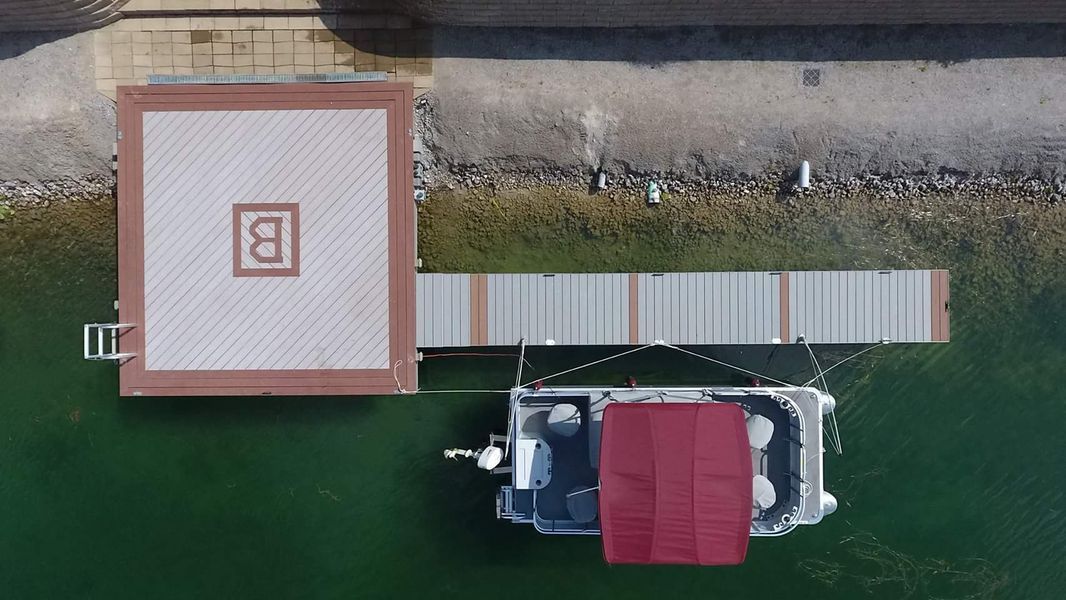 Overhead view of a boat docked at a pier next to a structure with a 