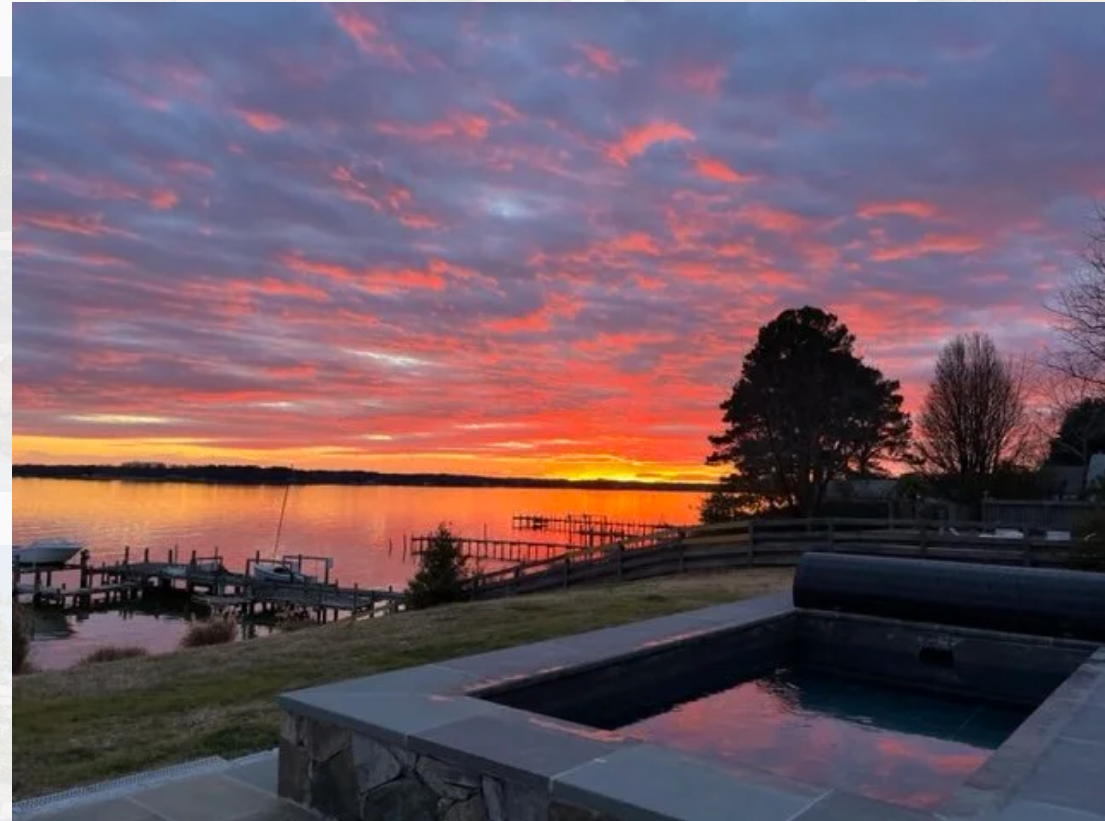 Sunset over water with fiery orange and pink sky
