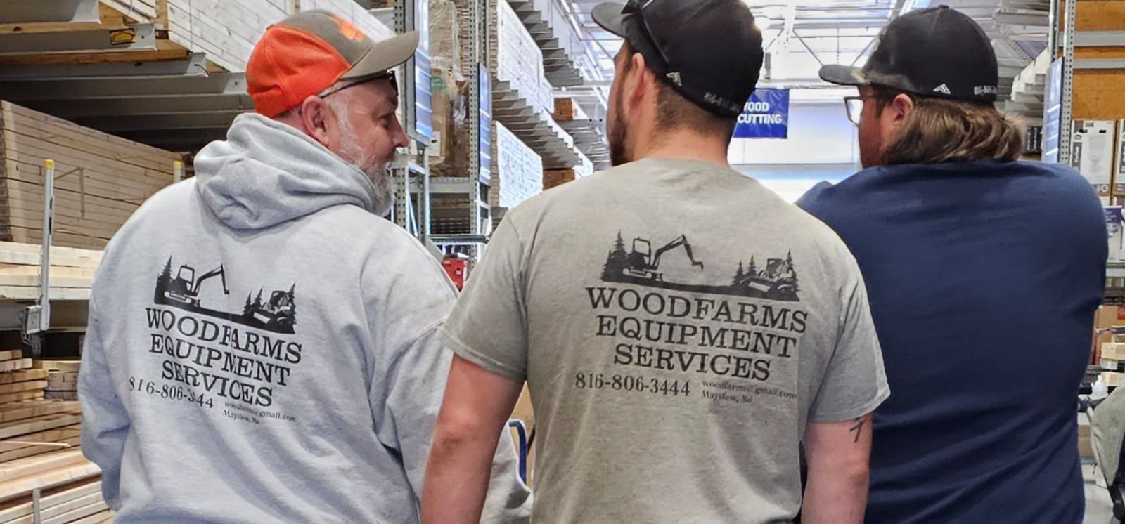 Three men are standing in a warehouse.