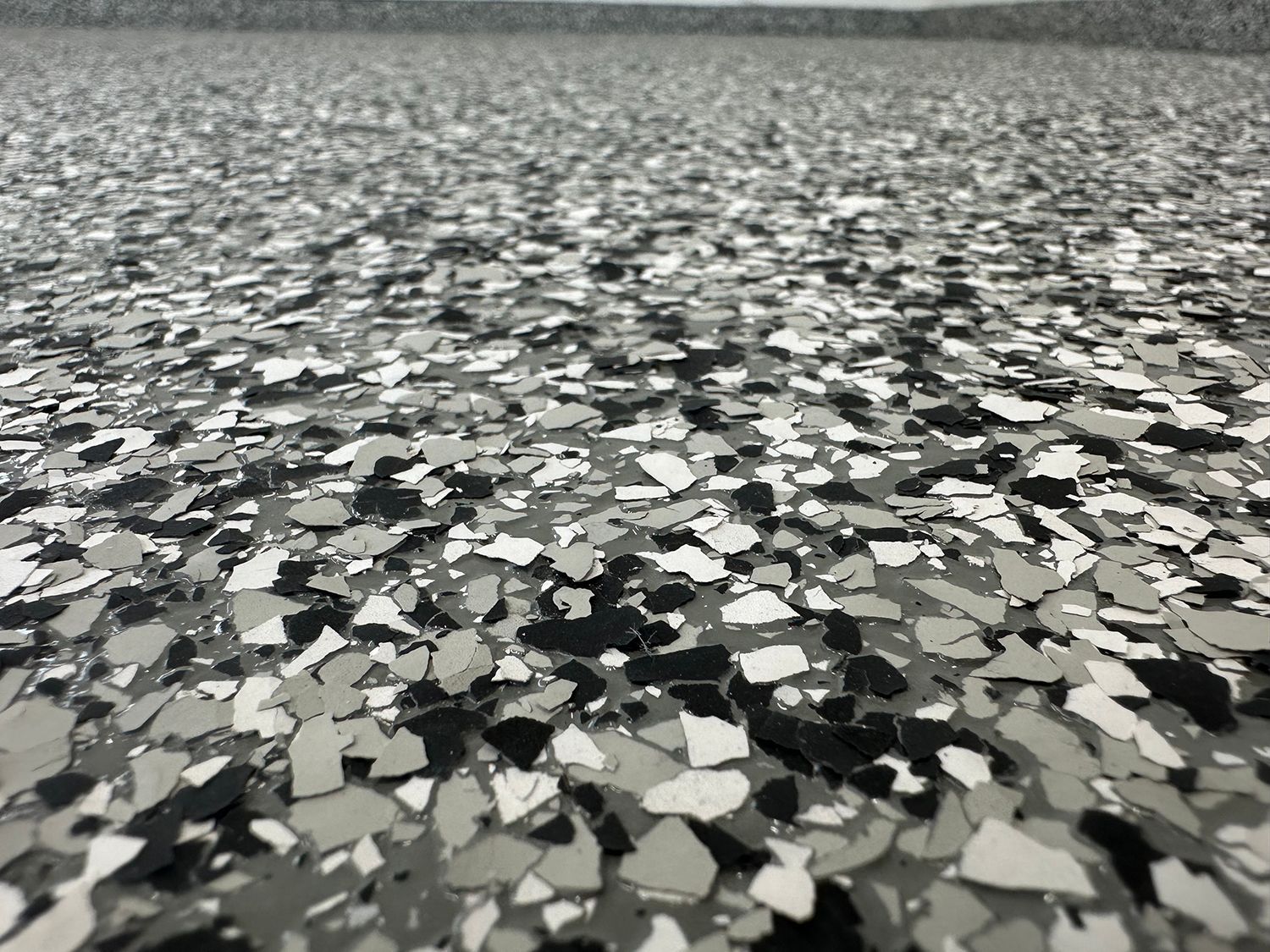 A close up of a black and white marble floor.