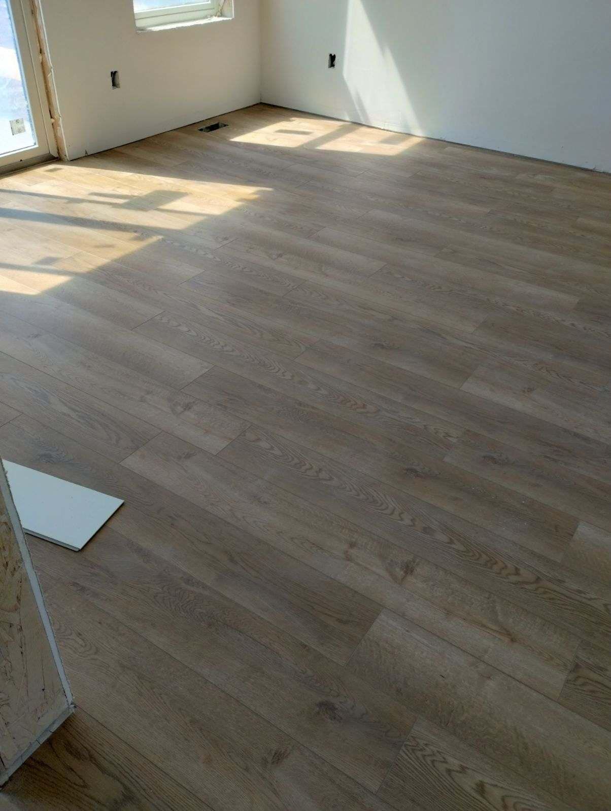 A room with a wooden floor and white walls.