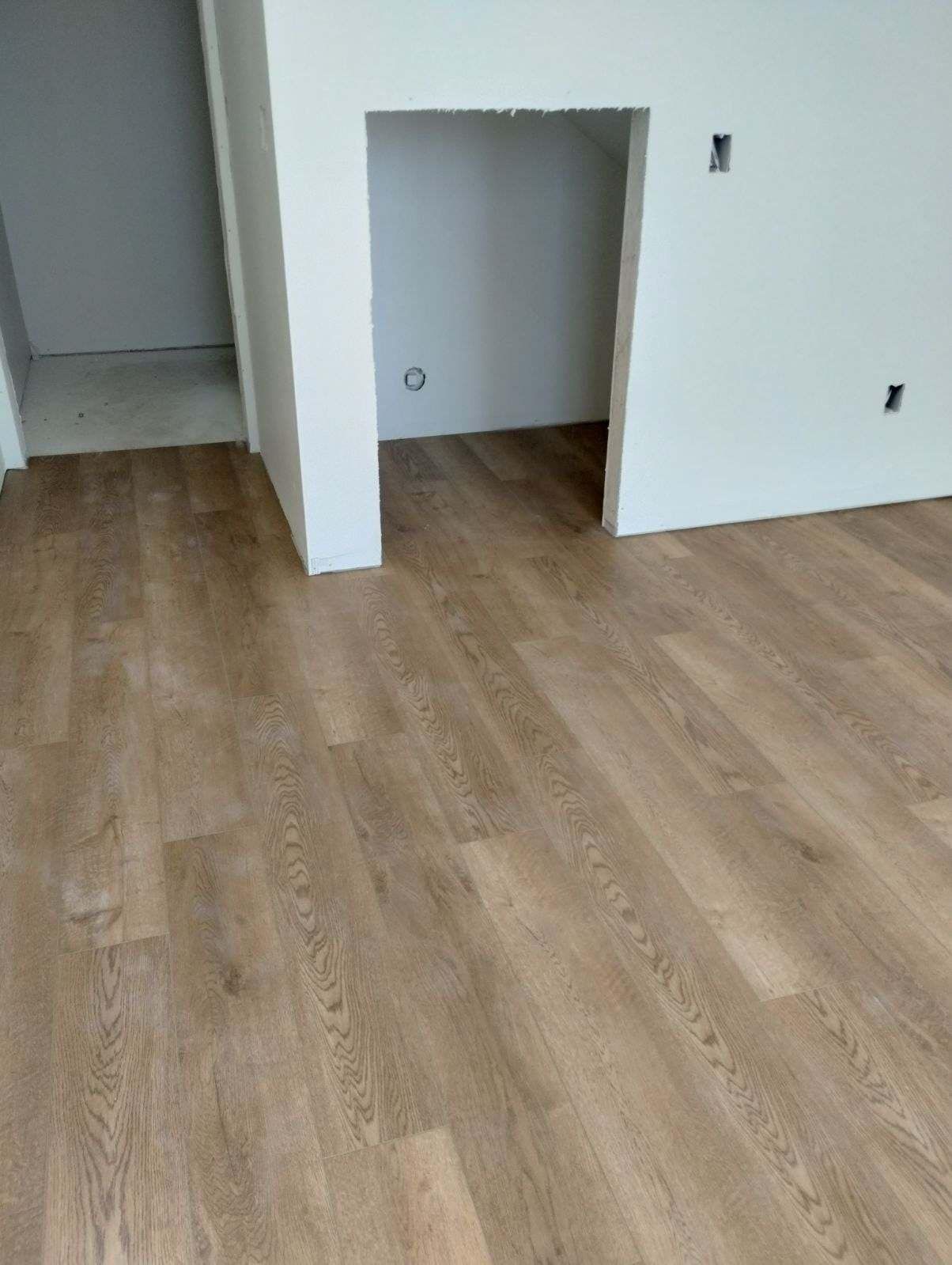 A room with a wooden floor and white walls.