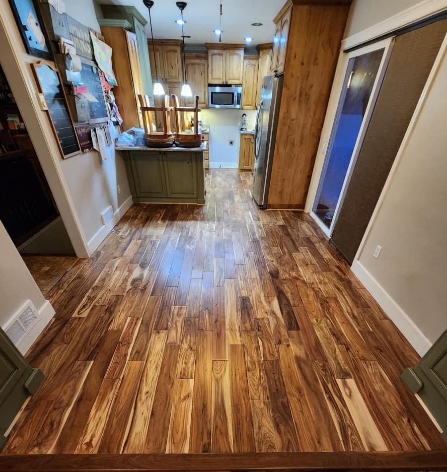A kitchen with hardwood floors and stainless steel appliances