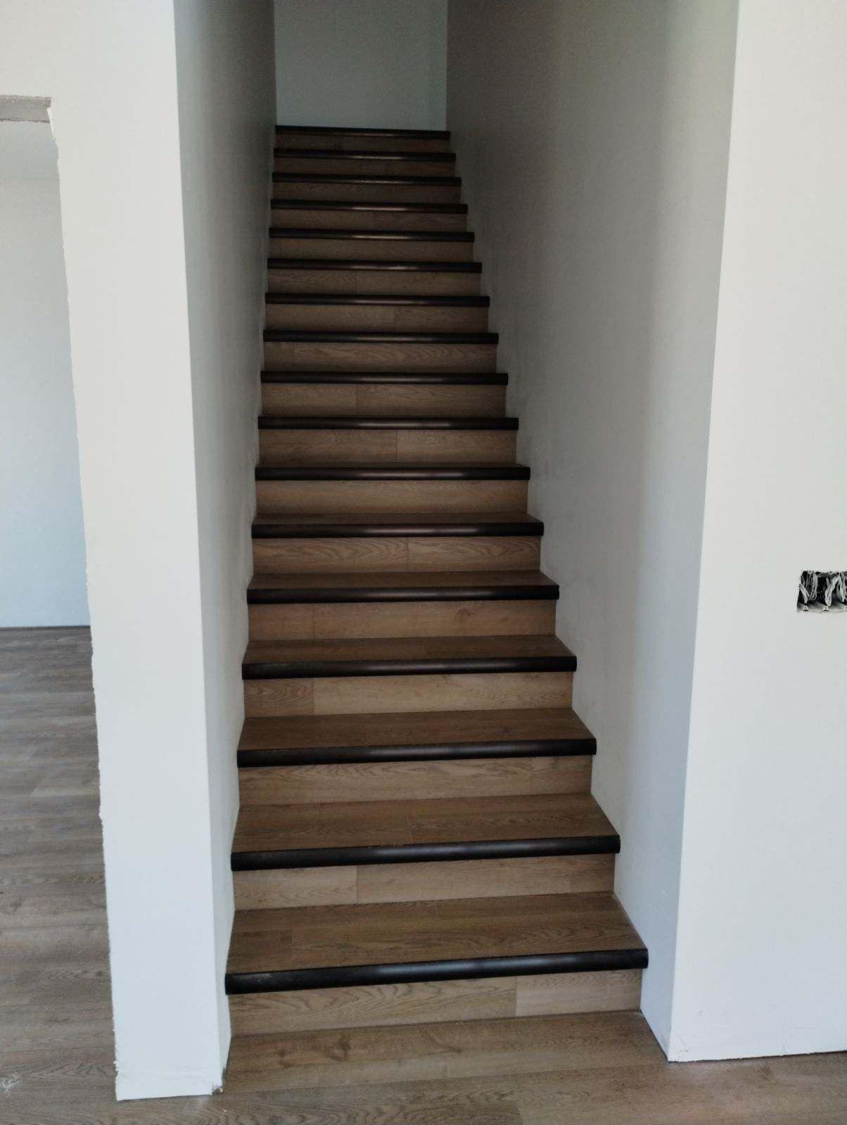 A set of stairs leading up to the second floor of a house.