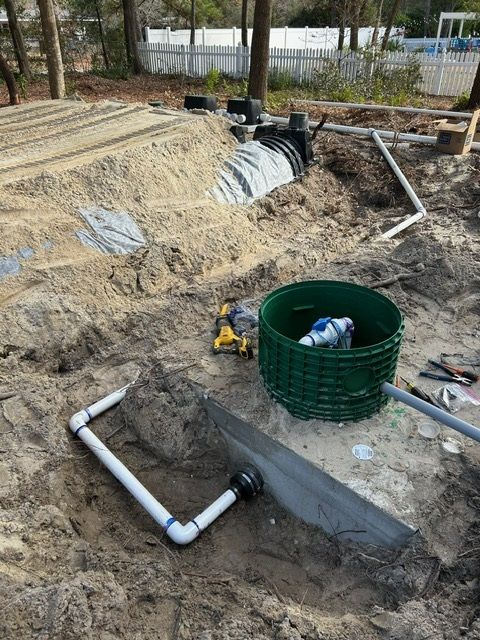 A drainage system is being installed in the dirt.