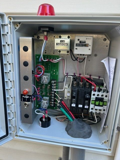The inside of an electrical box with a red light on top