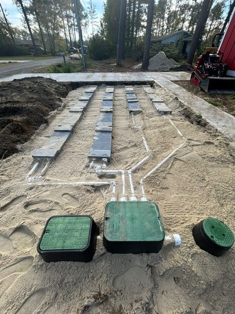 A septic system is being installed in the sand.