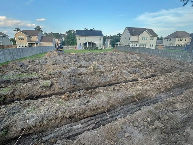 A large pile of dirt is in the middle of a residential area