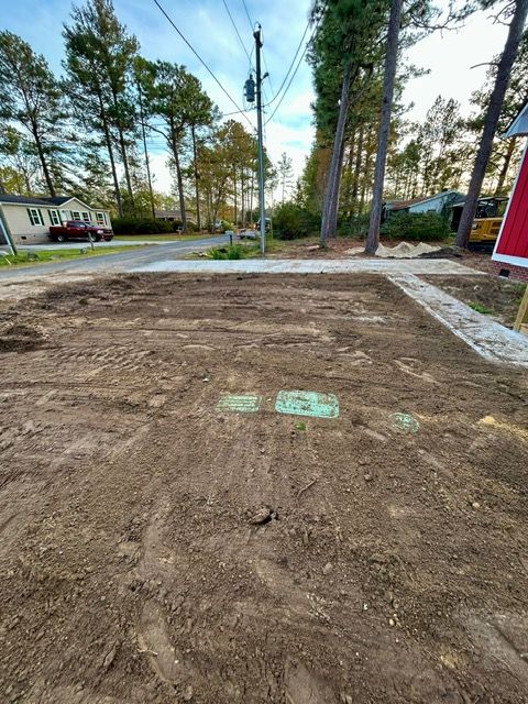 A lot of dirt is sitting on the side of a road.