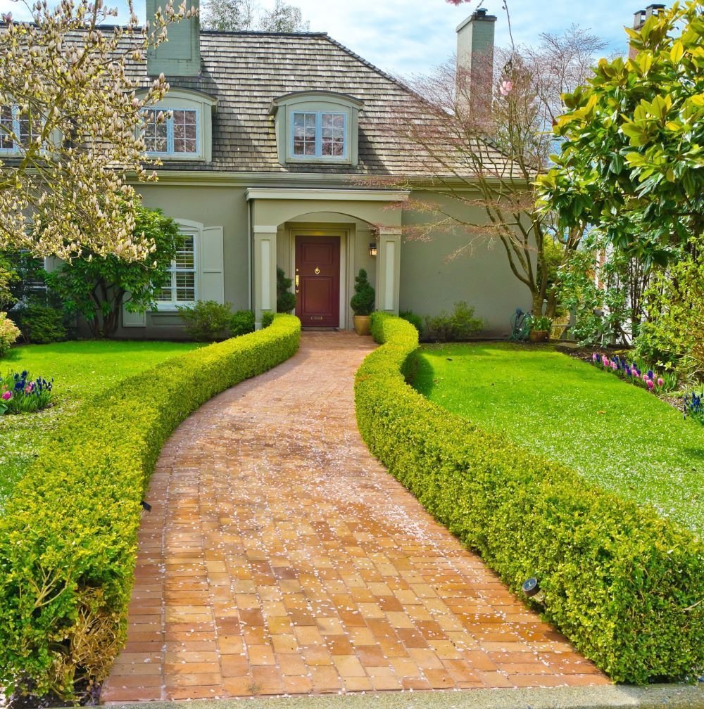 A house with a brick walkway leading to the front door