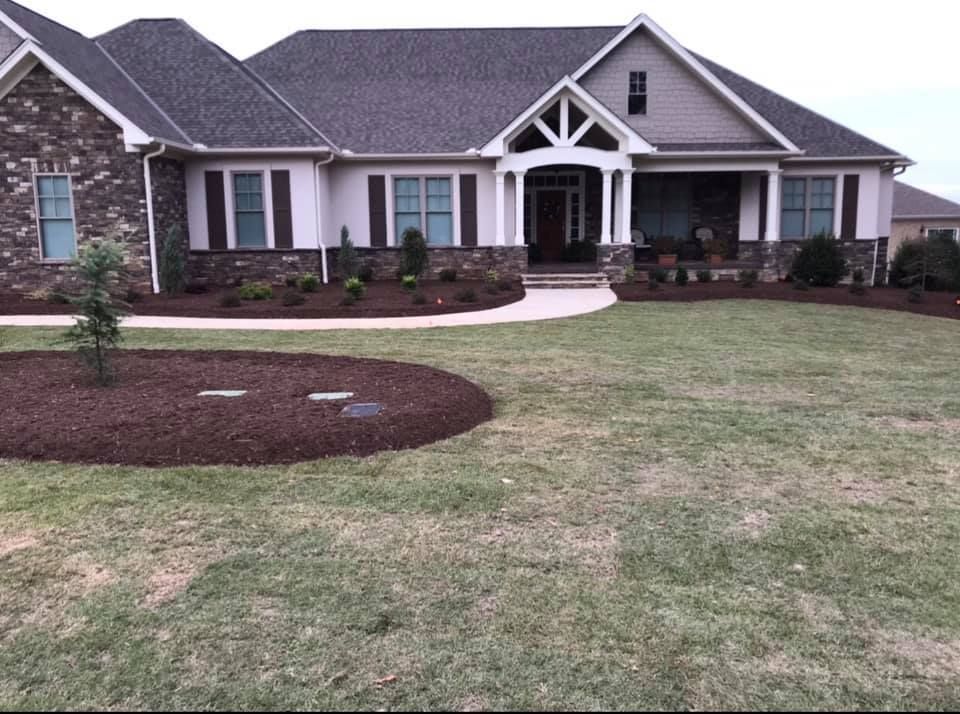 A large house with a lush green lawn in front of it