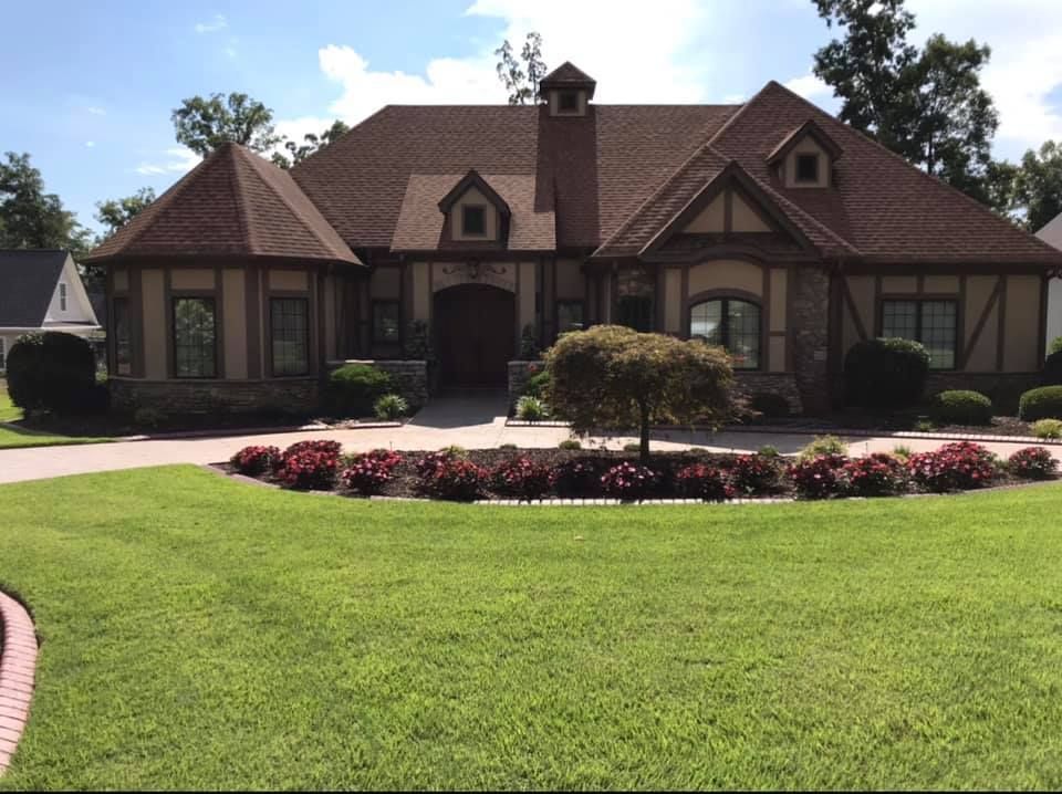 A large house with a lush green lawn in front of it