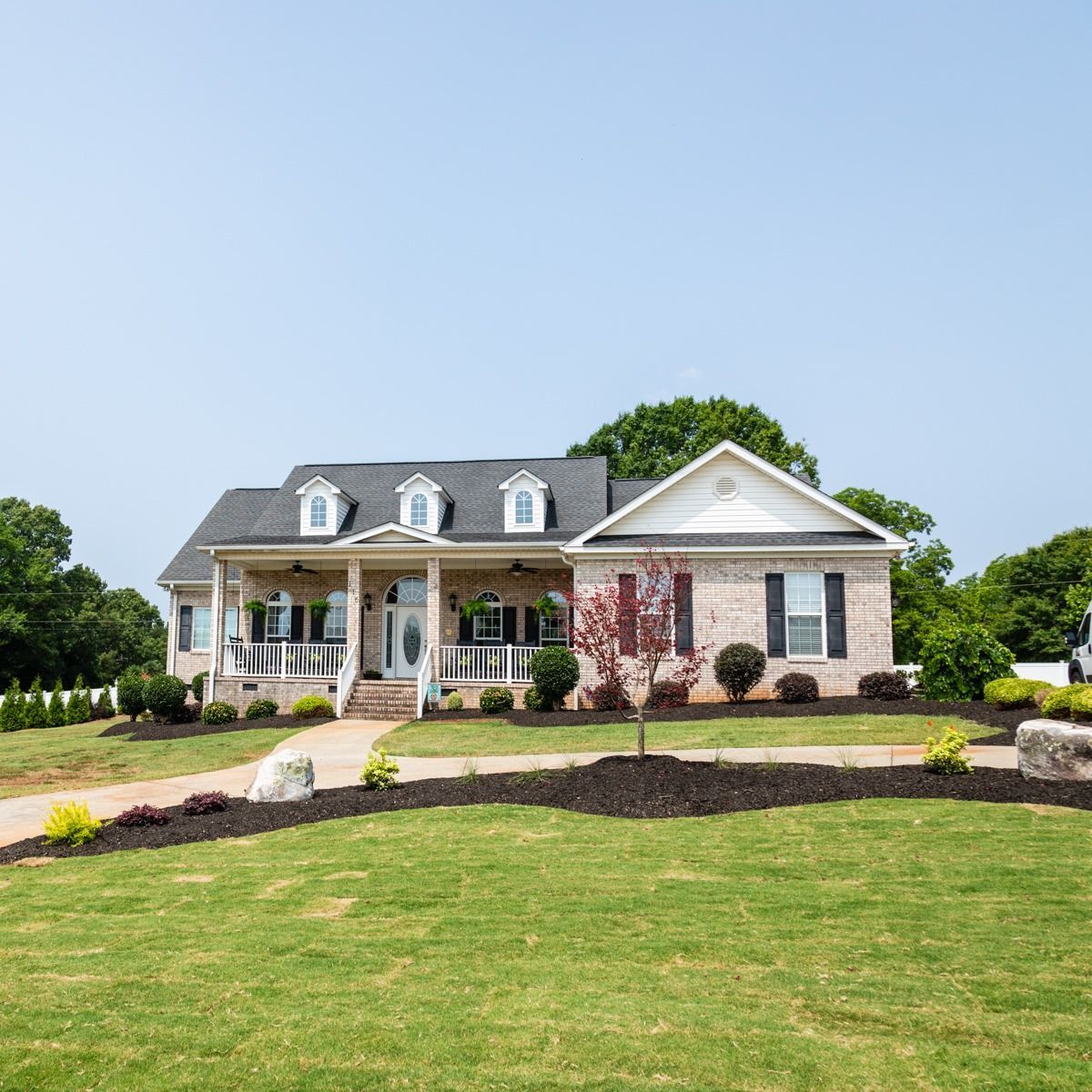 A large house with a large lawn in front of it