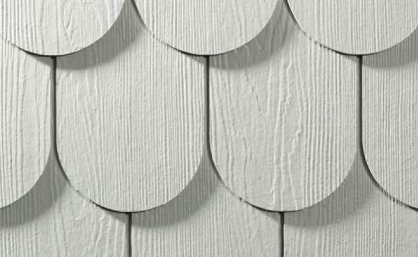 White, scalloped siding with vertical wood grain texture.