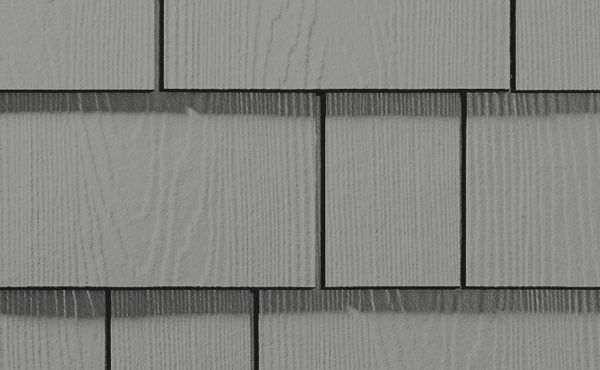 Gray composite shingle siding with wood grain texture.