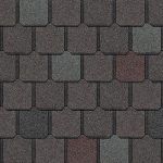 Close-up of asphalt shingles with a mix of brown, gray, and red tones.