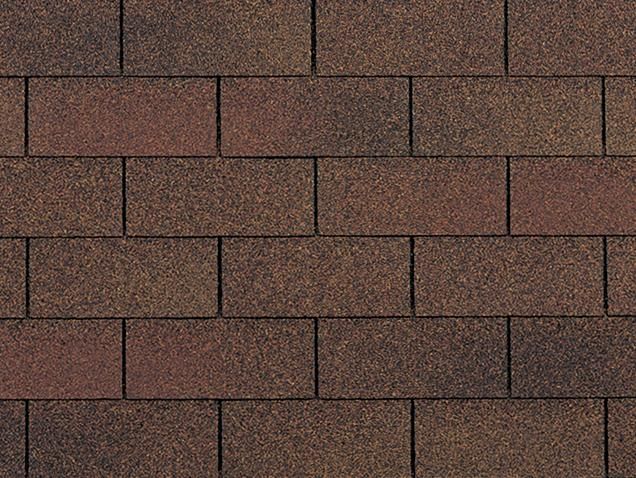 Brown asphalt roofing shingles in a brickwork pattern.