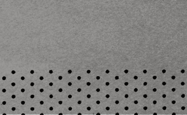 Gray surface with evenly spaced black circular perforations along the bottom edge.