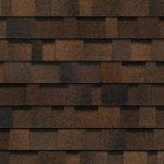 Brown and dark-brown asphalt roof shingles in a brick-like pattern.