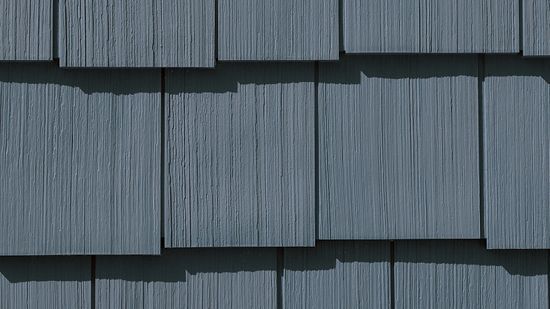 Blue-gray cedar shake siding with textured vertical grain.